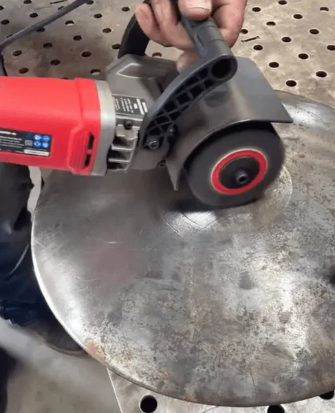 Image of someone sandblasting a piece of metal to remove the rust