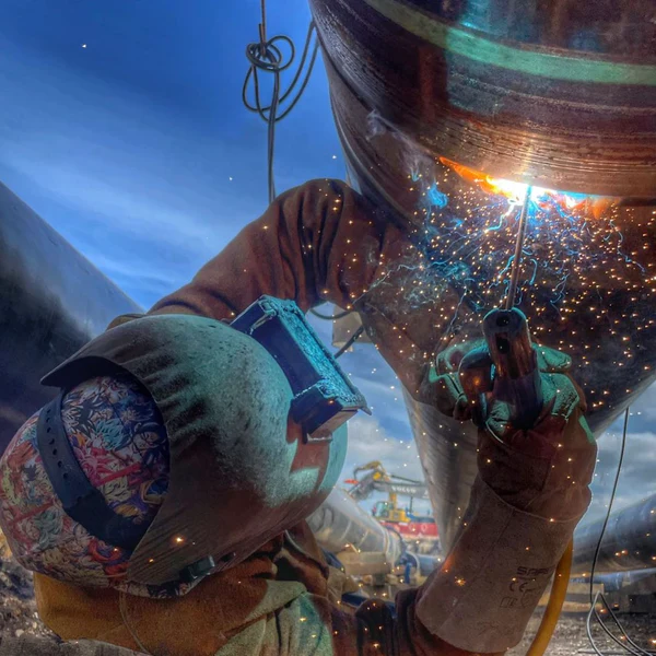 Image of a metal being welded onto a metal base