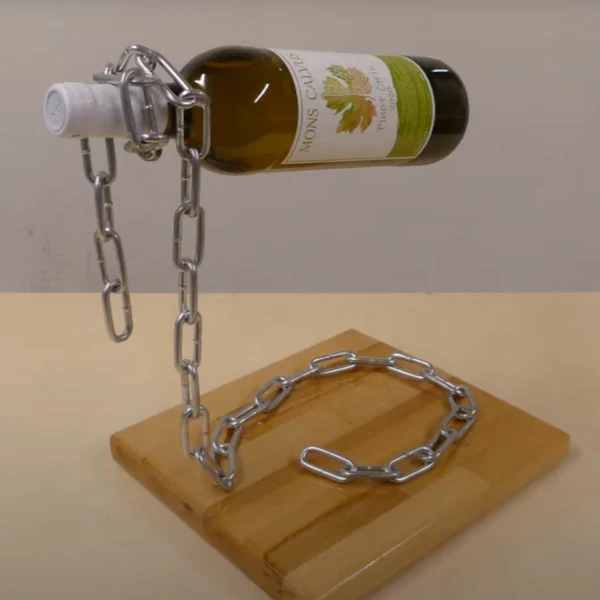 Image f a wine bottle that looks like it is floating horizontally with a chain hanging from it