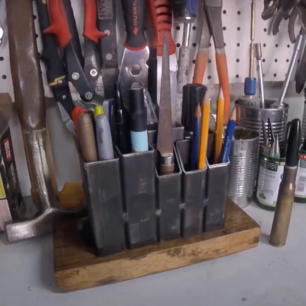 Image of metal rectangles welded together to create a pencil holder