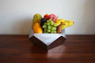 Image of a welded steel bowl with fruit inside of it